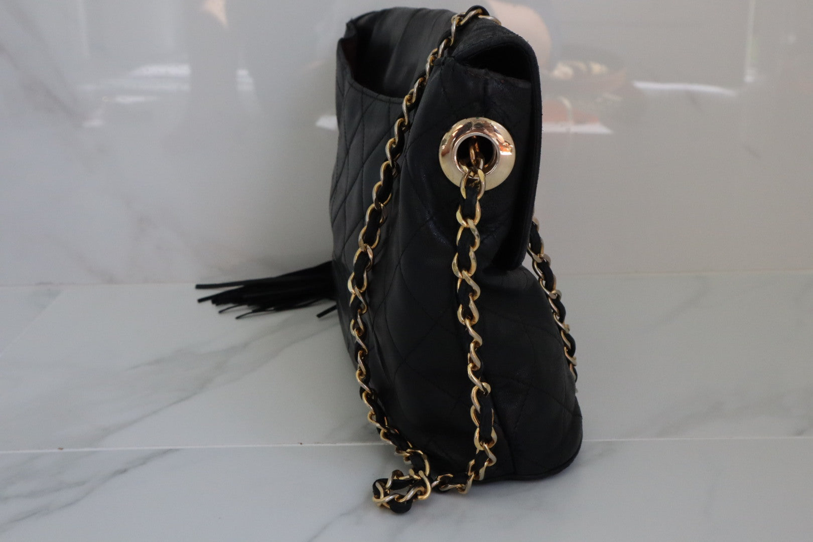 CHANEL. Vintage quilted shoulder bag in black calf leath…